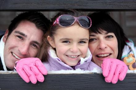 parents and their daughter in the mountains